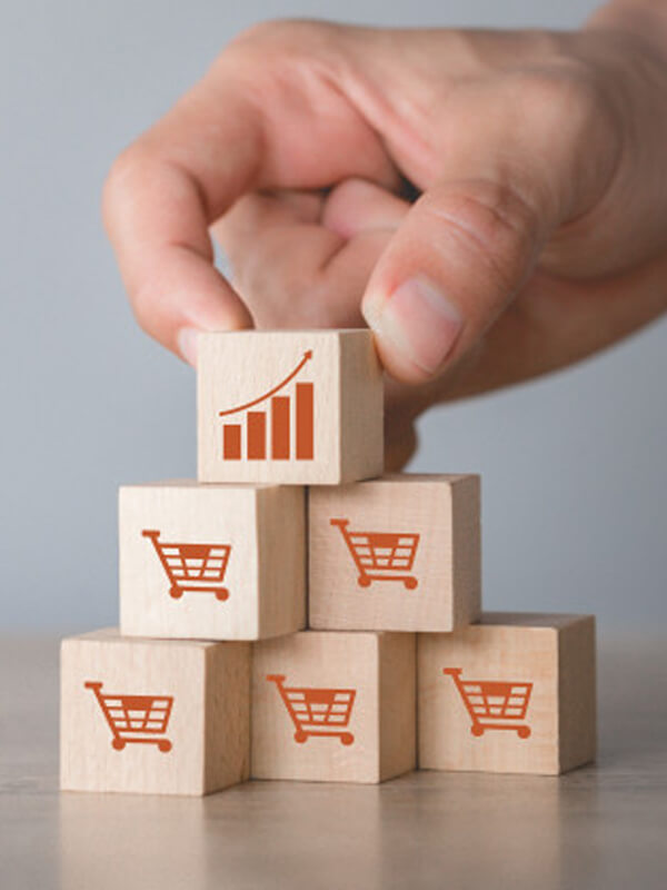 hand-arranging-wood-block-stacking-with-icon-graph-shopping-cart-symbol-upward-direction